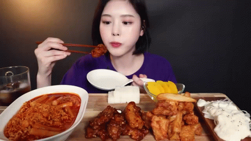 Woman Eating Food With Chopsticks GIF