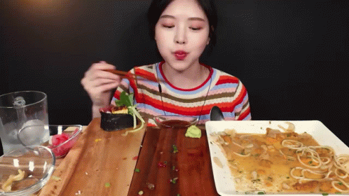 Woman Eating Food With Chopsticks GIF