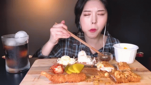 Woman Eating Fried Food With Chopsticks And Soda GIF