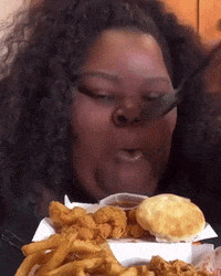 Woman Eating Fried Food With Fork