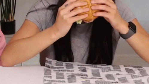 Woman Eating Hamburger With Watch GIF