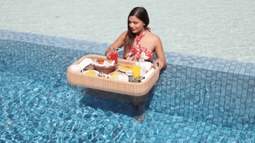 Woman Eating In The Pool GIF