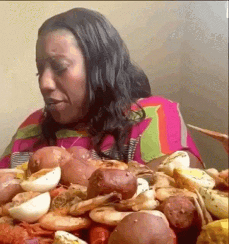 Woman Eating Large Pile of Food