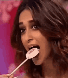Woman Eating Lollipop With Mouth Open GIF