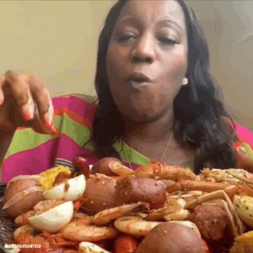 Woman Eating Lots of Food from Mardi Gras Don Tia Plate
