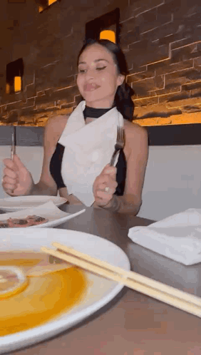 Woman Eating Meal with Chopsticks and Fork