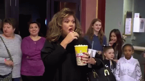 Woman Eating Popcorn in Theater