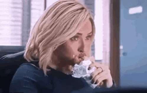 Woman Eating Sandwich At Computer GIF