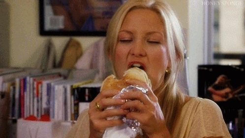 Woman Eating Sandwich in Living Room