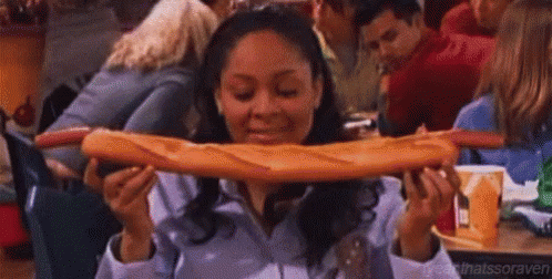 Woman Eating Very Long Loaf Of Bread GIF