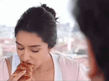 Woman Eating With Eyes Closed GIF