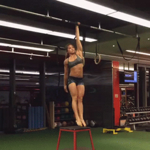 Woman Exercising in Gym with TCM Sign