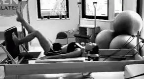 Woman Exercising on Pilates Machine Black and White