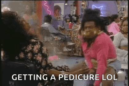 Woman Feet with Red Toenails and Toe Separators