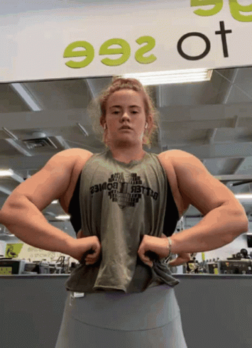 Woman Flexing Muscles At Sign 992 GIF