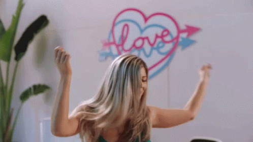 Woman Flexing Muscles by Heart Wall with Love