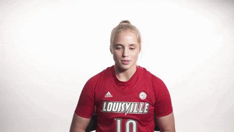 Woman Flexing Muscles in Red Louisville Jersey
