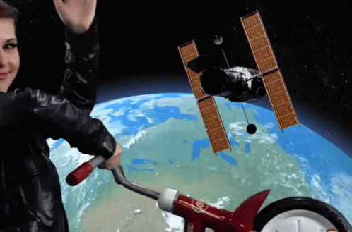 Woman Floating Against Planet With Bicycle GIF