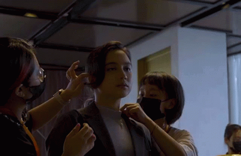 Woman Getting Hair Done by Two Masked Women