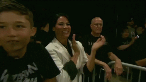 Woman Giving Peace Sign in Crowd