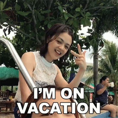 Woman Giving Peace Sign Next to Swimming Pool Saying I'm On Vacation