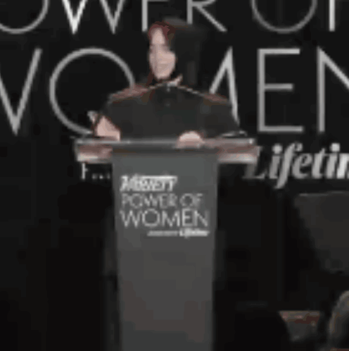 Woman Giving Speech at Power of Women Event