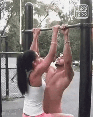 Woman Helping Man Do Pull Up