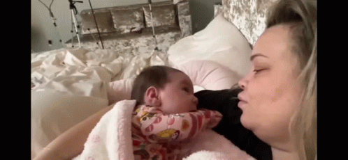 Woman Holding Baby and Kissing