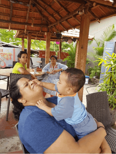 Woman Holding Baby Reaching For Face GIF