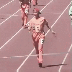 Woman Holding Baton Crossing Finish Line On Track GIF