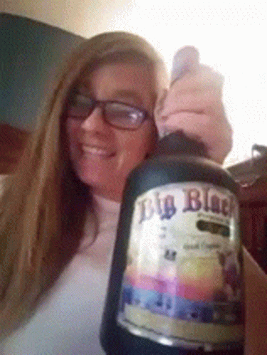 Woman Holding Big Black Beer