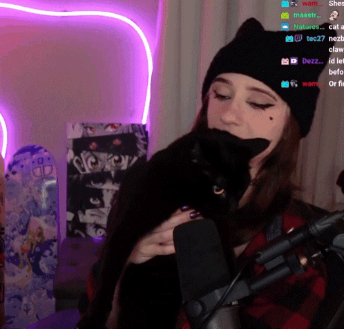 Woman Holding Black Cat Near Microphone Purple Heart