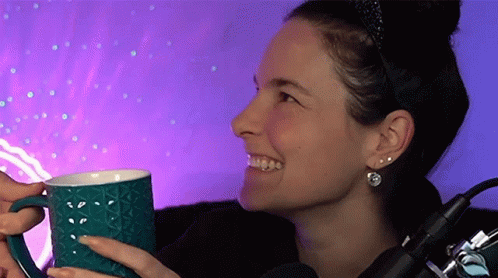 Woman Holding Blue Mug in Front of Microphone
