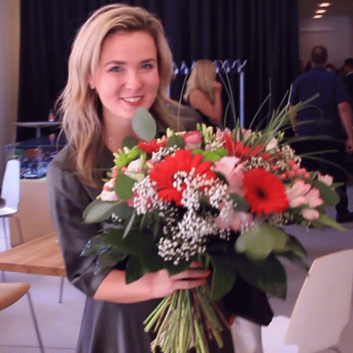 Woman Holding Bouquet Of Flowers GIF