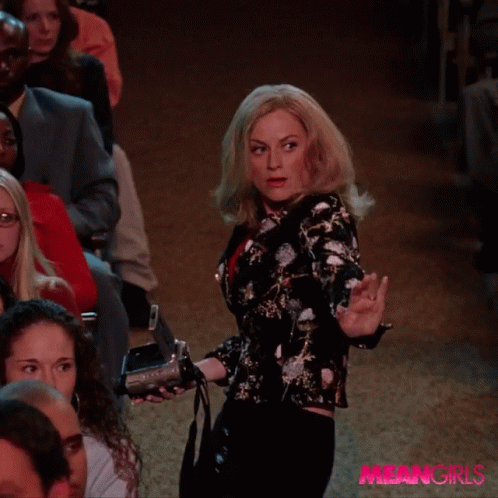 Woman Holding Camera in Front of Crowd Meangirls