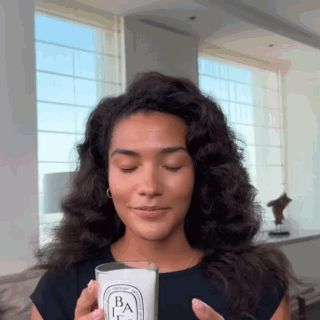 Woman Holding Candle With Letter B GIF