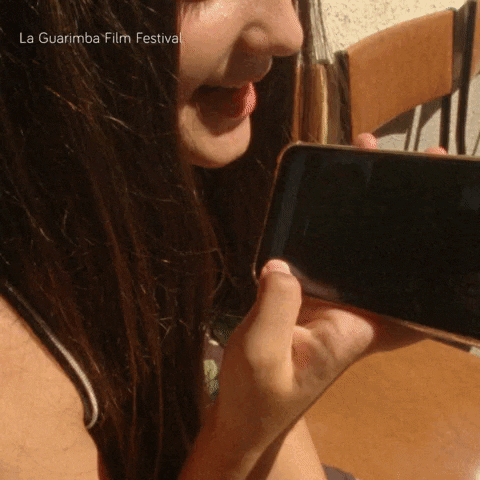 Woman Holding Cell Phone La Guarimba Film Festival
