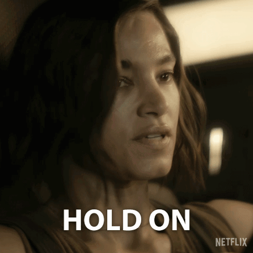 Woman Holding Cell Phone Saying Hold