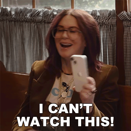 Woman Holding Cell Phone Saying I Can't Watch This