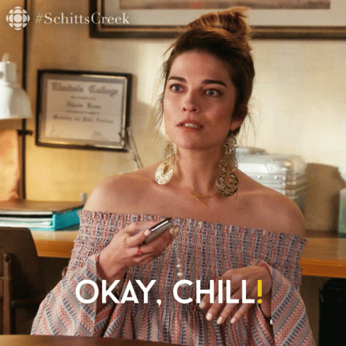 Woman Holding Cell Phone Says Okay Chill GIF