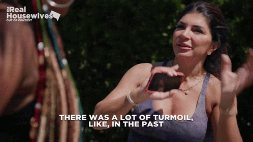 Woman Holding Cell Phone Says There Was A Lot Of Turmoil In The Past GIF