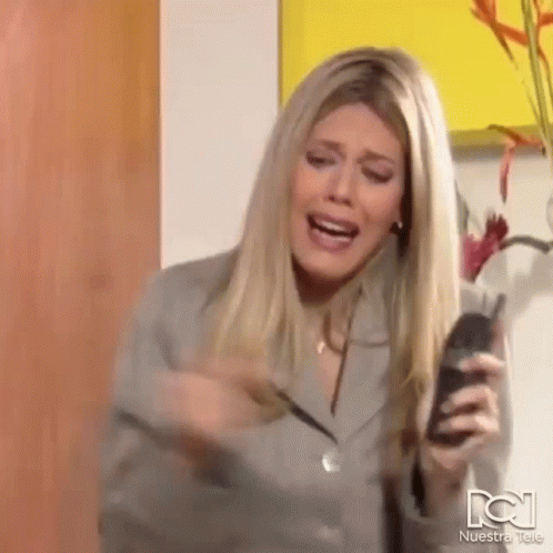 Woman Holding Cell Phone Screaming