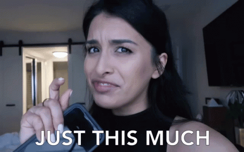 Woman Holding Cell Phone With Just This Much