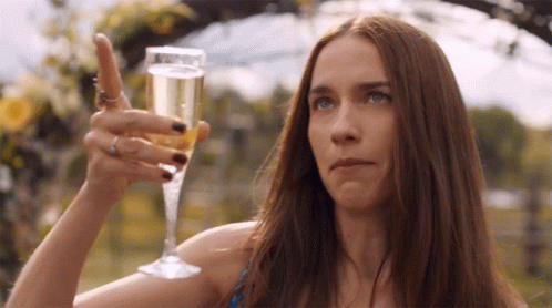 Woman Holding Champagne and Pointing Up