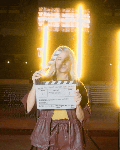 Woman Holding Clapper Board Saying The Show