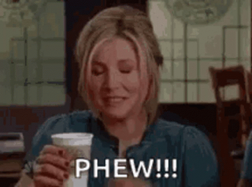 Woman Holding Coffee And Smiling GIF