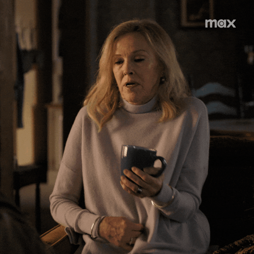 Woman Holding Coffee Cup With Max Logo