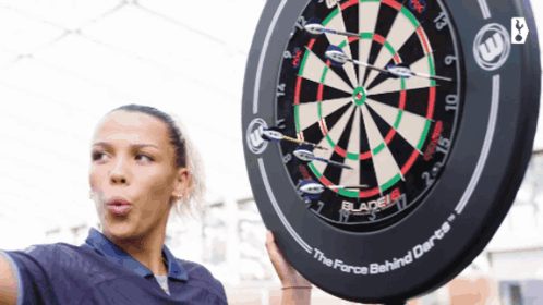 Woman Holding Dart Board Saying Force Behind Darts