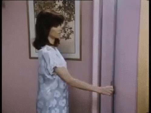 Woman Holding Door Open