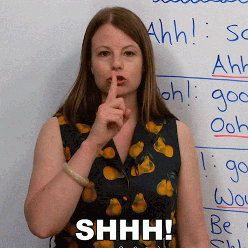 Woman Holding Finger to Lips Shh